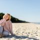 Happy woman on beach during cold spring weather