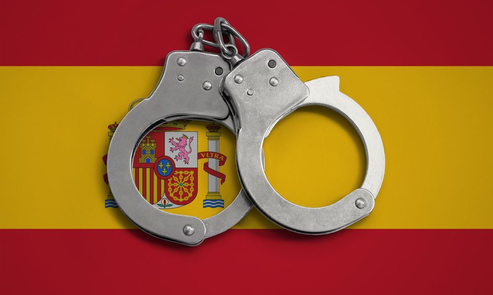 Spain flag and police handcuffs