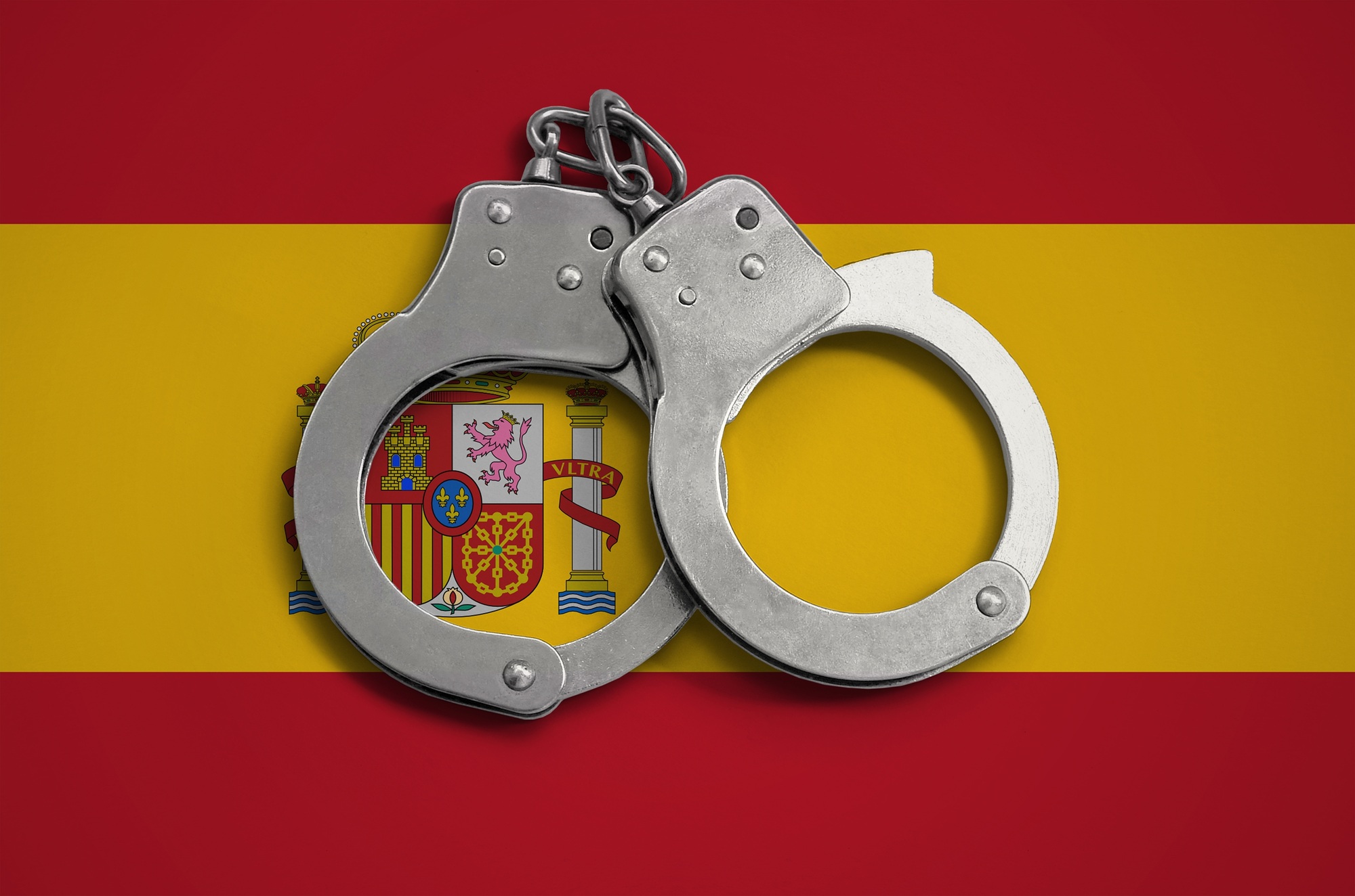 Spain flag and police handcuffs