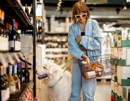 Woman visiting wine shop with her dog