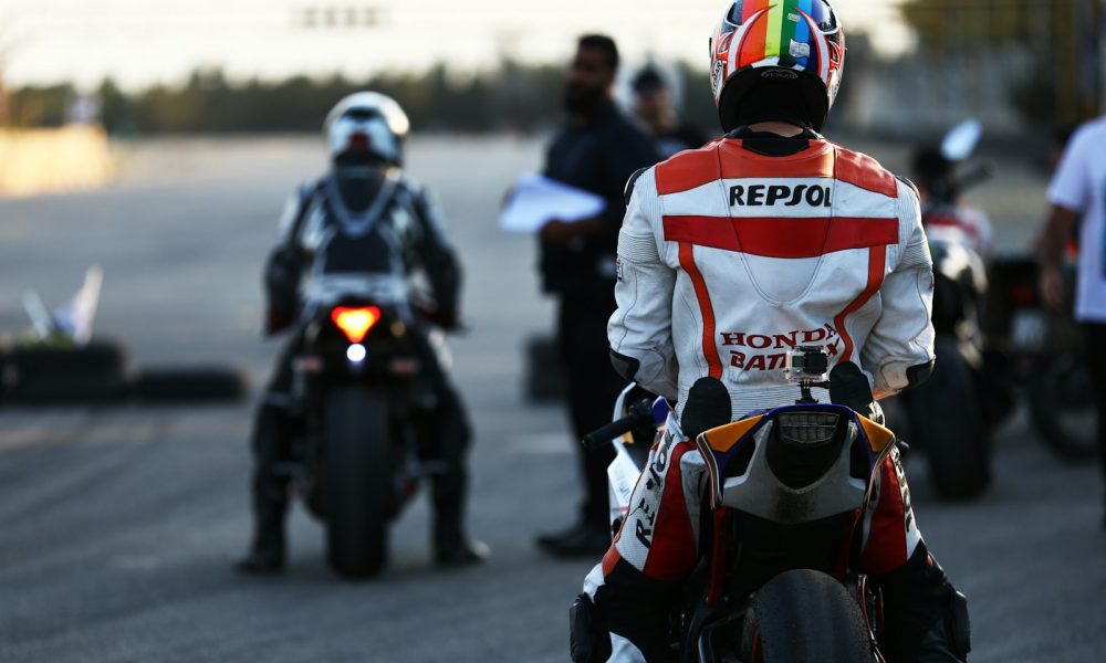person sitting in a motorcycle during daytime selective photography