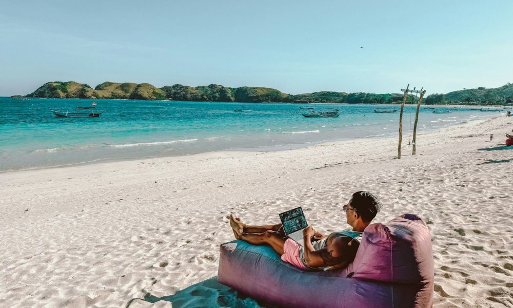 a man sitting on a bean bag on the beach