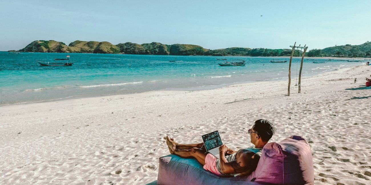 a man sitting on a bean bag on the beach