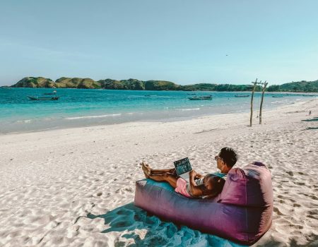 a man sitting on a bean bag on the beach