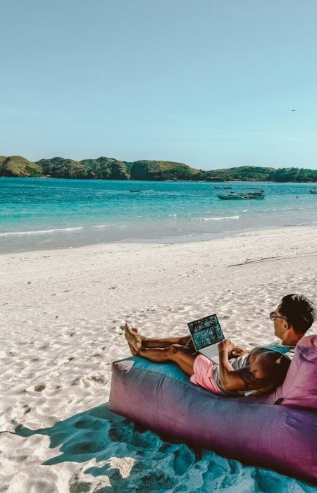 a man sitting on a bean bag on the beach