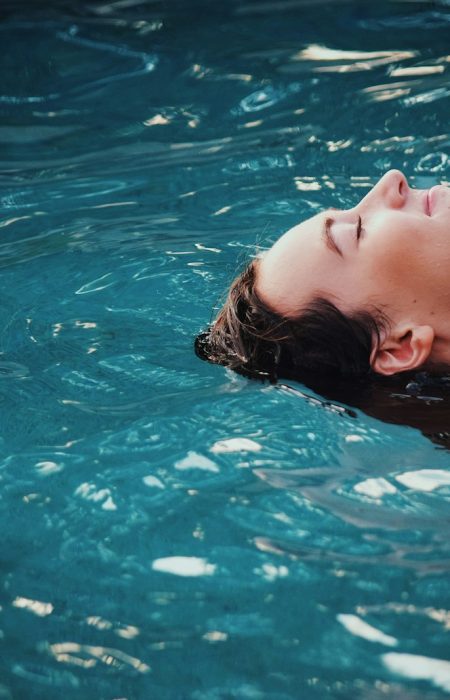 woman floating on body of water