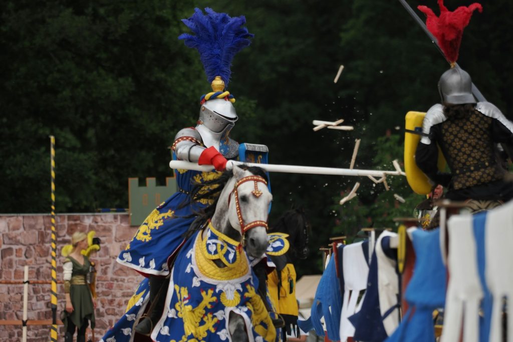 Knights jousting on horseback in a medieval reenactment.