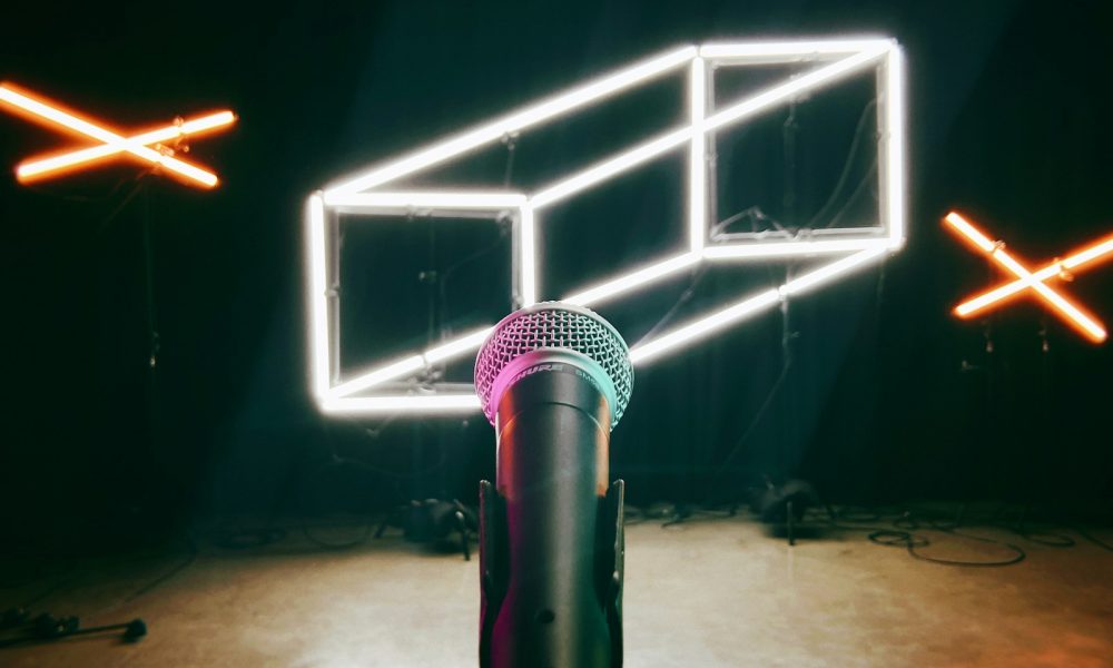 a microphone in a dark room with neon lights