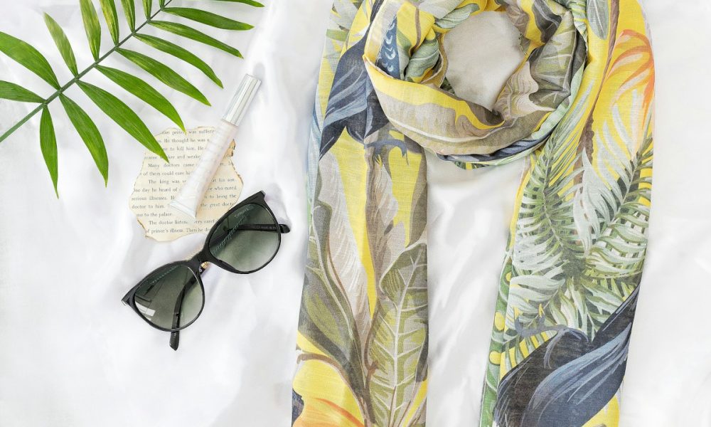 black sunglasses on yellow and white textile