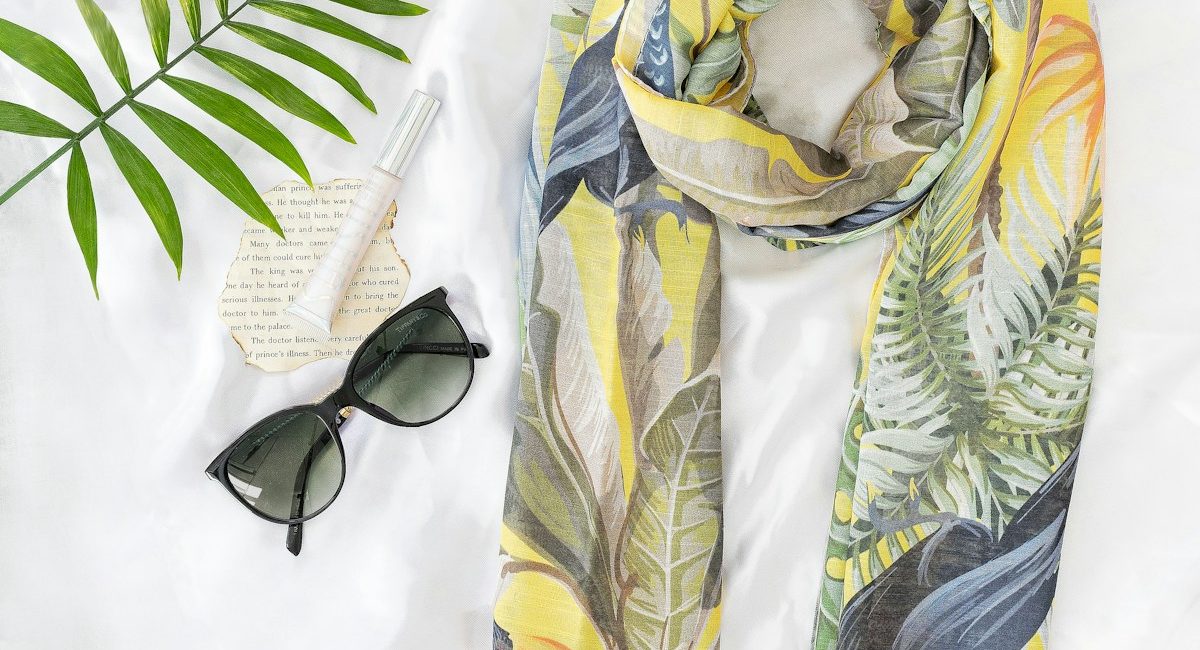 black sunglasses on yellow and white textile