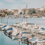 white and blue boats on dock during daytime