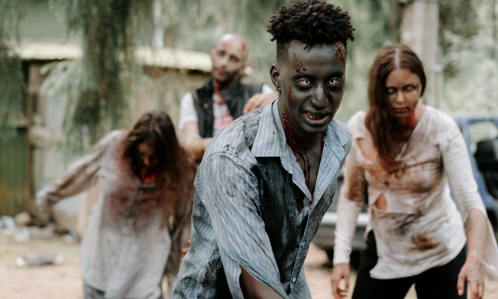 Eerie scene of zombies in a forest, perfect for Halloween or horror themes.