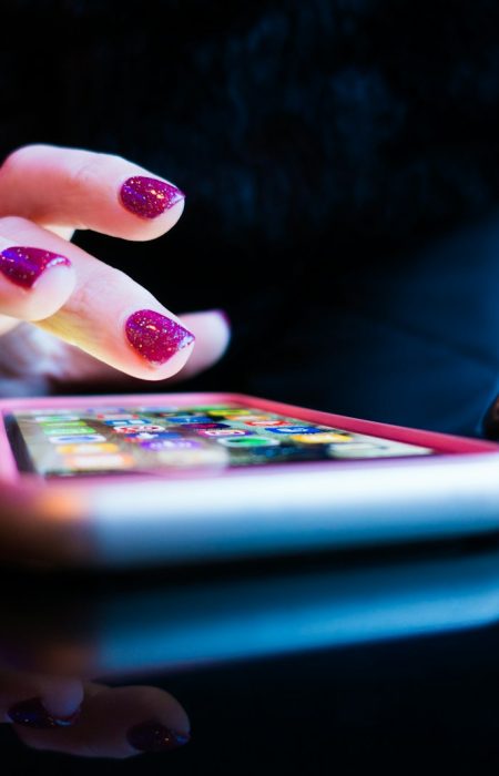 person using black smartphone with gray and pink case