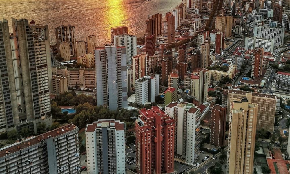 a view of a city with a body of water in the background