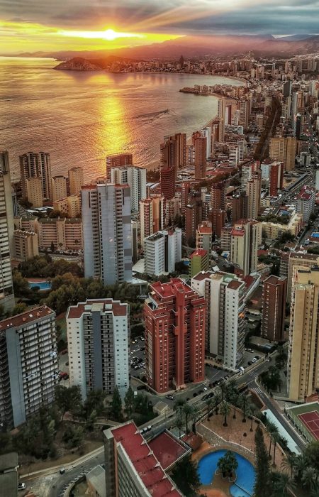 a view of a city with a body of water in the background