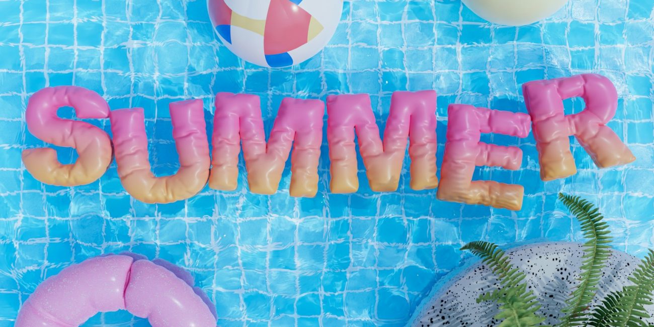 a pool with a pool float, inflatable toys, and the word summer