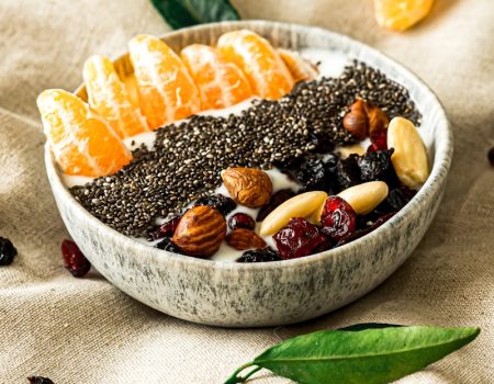 a bowl filled with fruit and nuts on top of a table