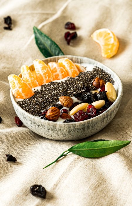 a bowl filled with fruit and nuts on top of a table