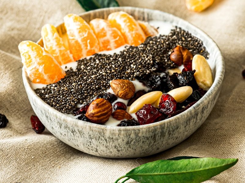 a bowl filled with fruit and nuts on top of a table