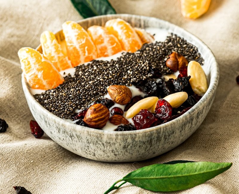 a bowl filled with fruit and nuts on top of a table
