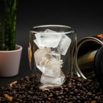 clear glass mug on coffee beans