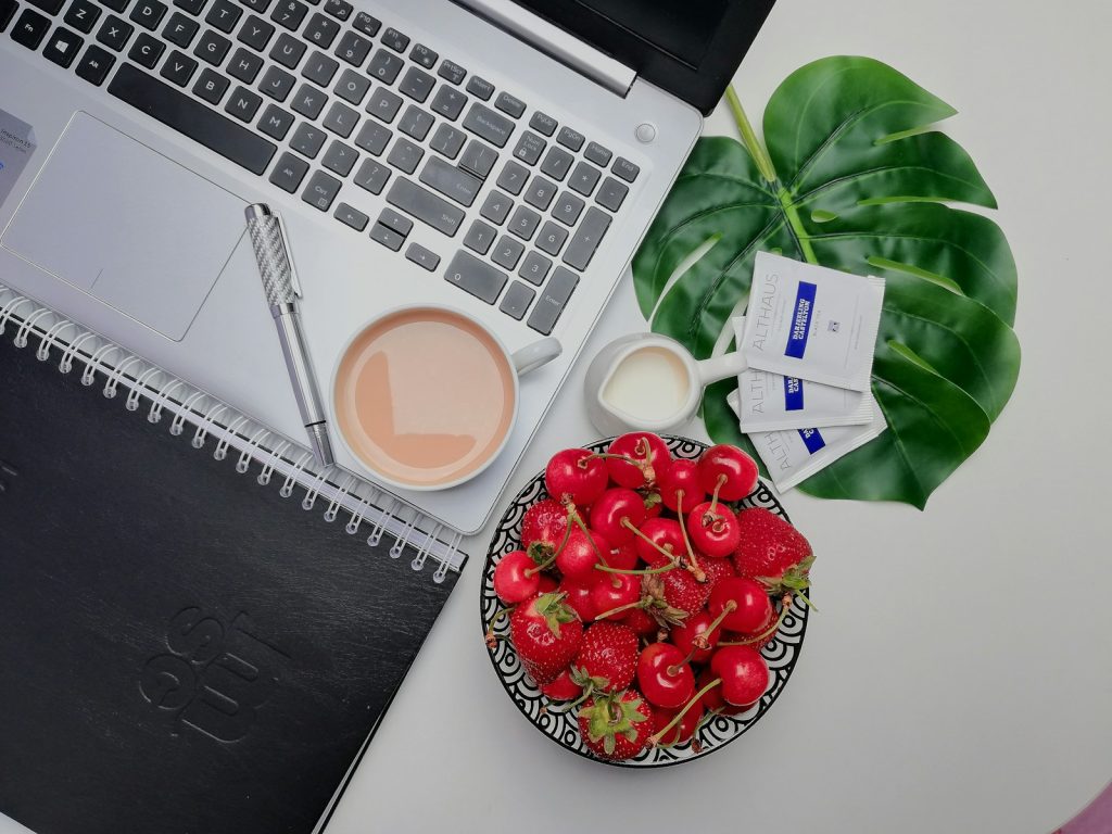 white ceramic mug on gray laptop computer