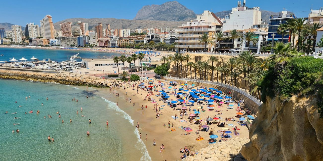 a beach with people and buildings by it