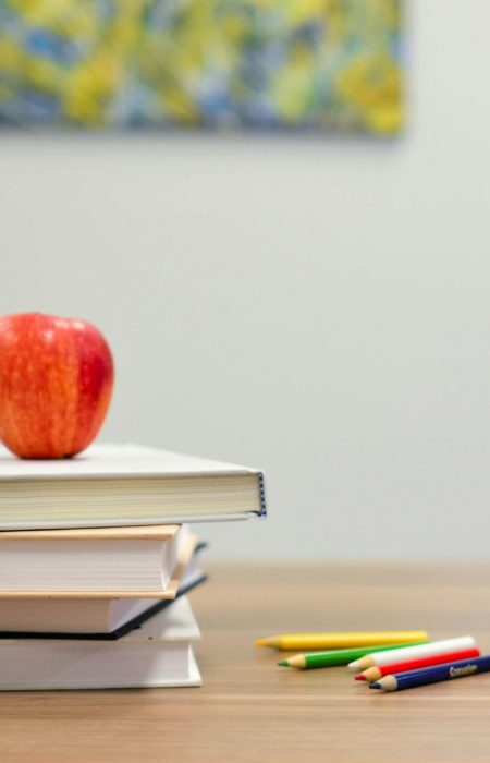 red apple fruit on four pyle books