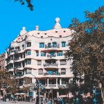 white and beige concrete building near trees