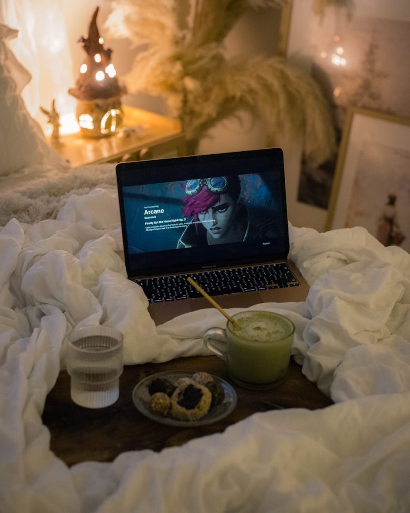 A laptop computer sitting on top of a bed
