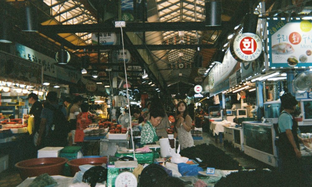 a group of people standing around a market
