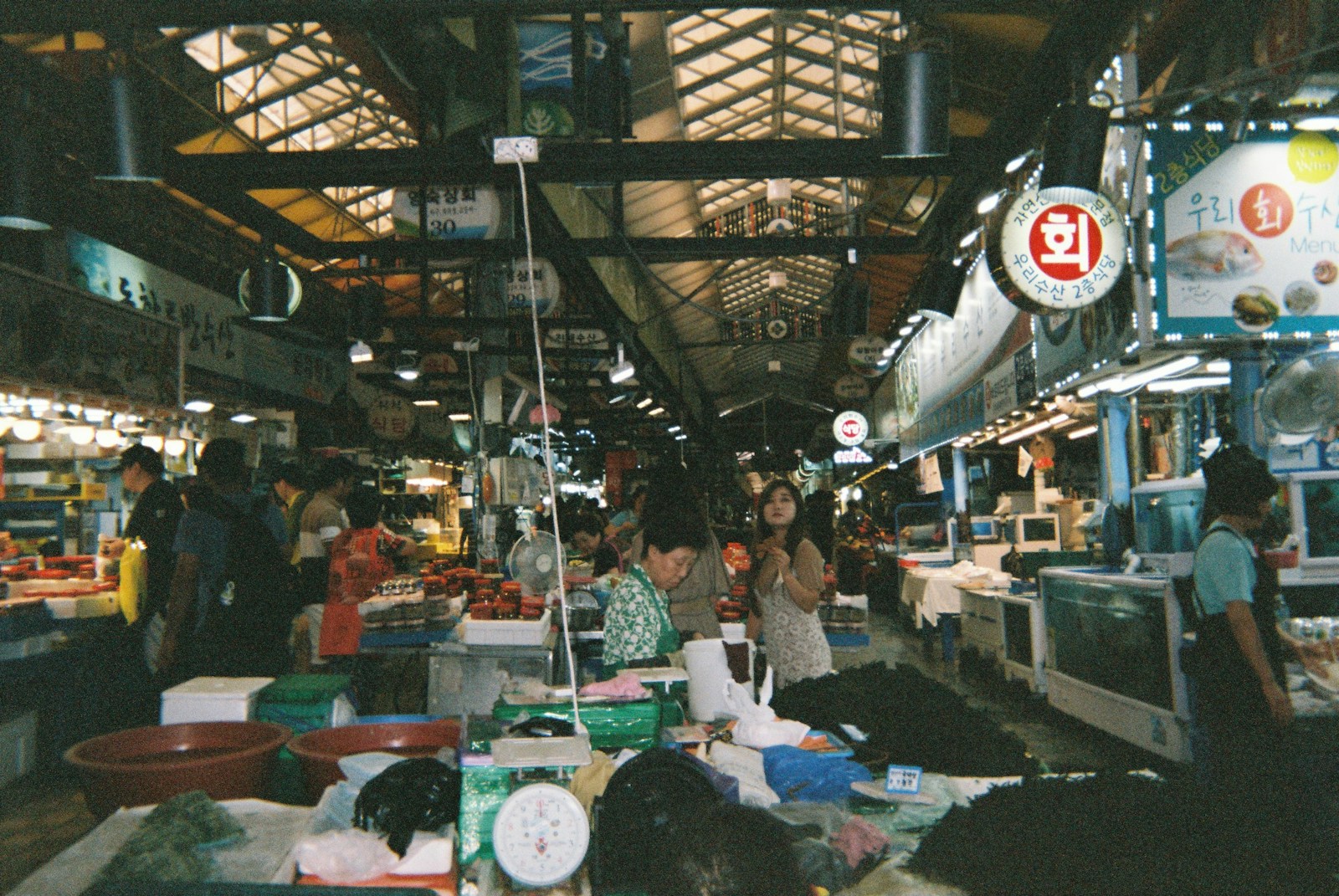 a group of people standing around a market