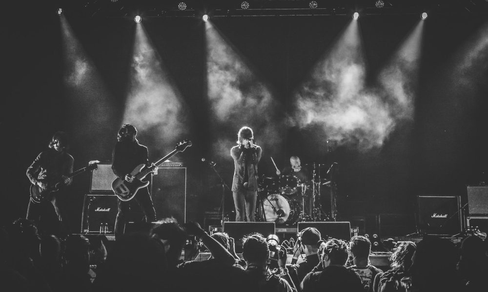 grayscale photo of band performing on stage