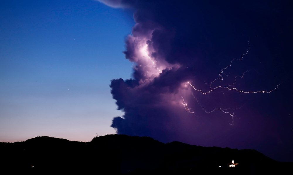 a large cloud with a lightning bolt coming out of it