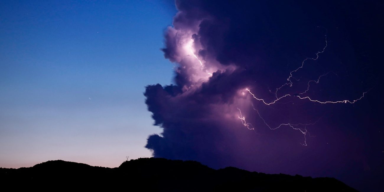 a large cloud with a lightning bolt coming out of it