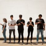 group of people standing on brown floor
