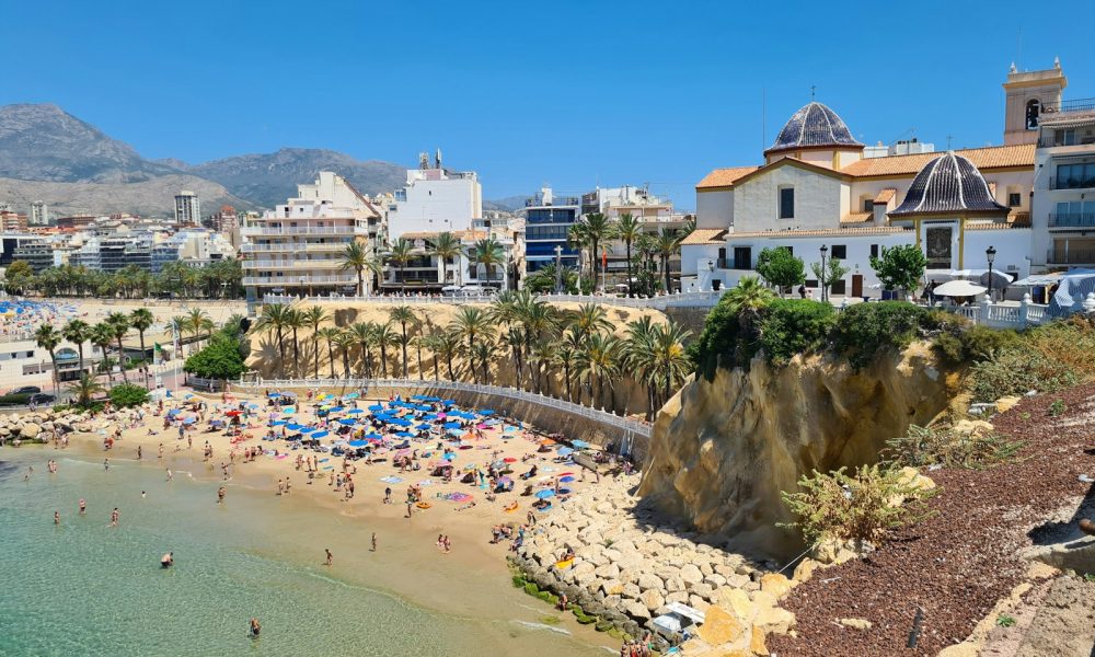 a beach with people and buildings