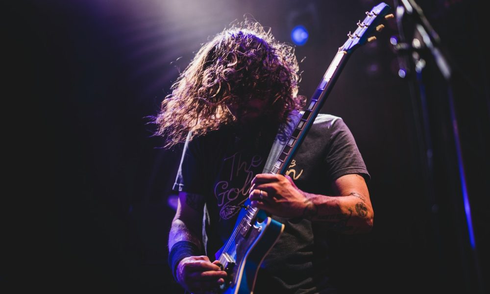 man playing electric guitar