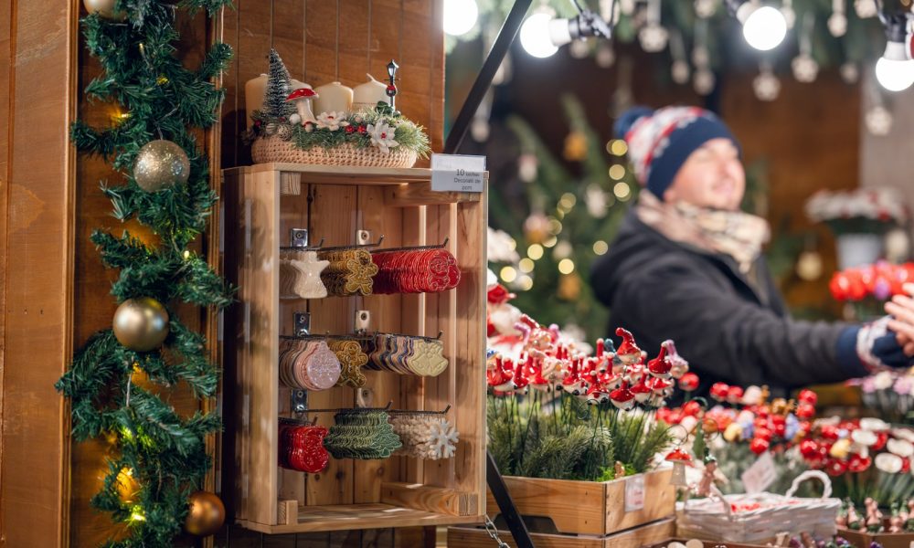 a woman standing in front of a christmas display
