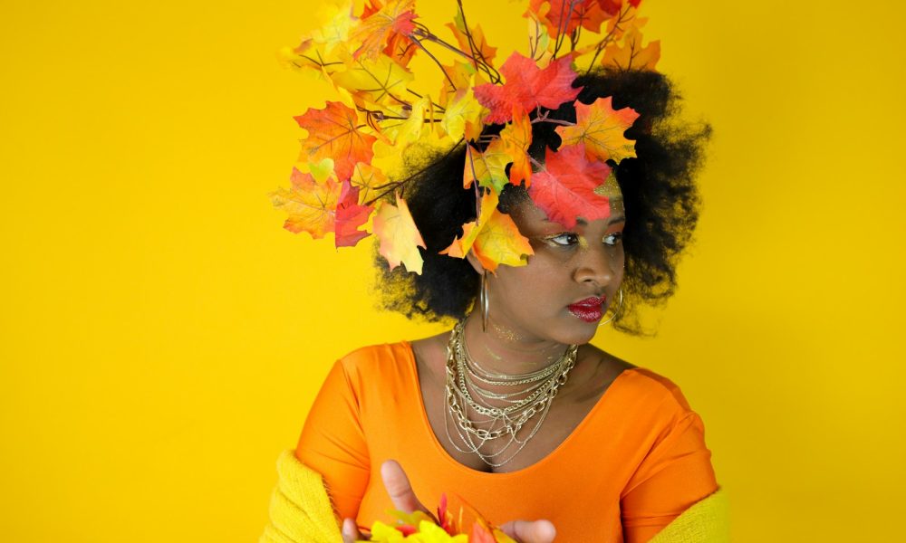 Woman with autumn leaves in her hair and outfit