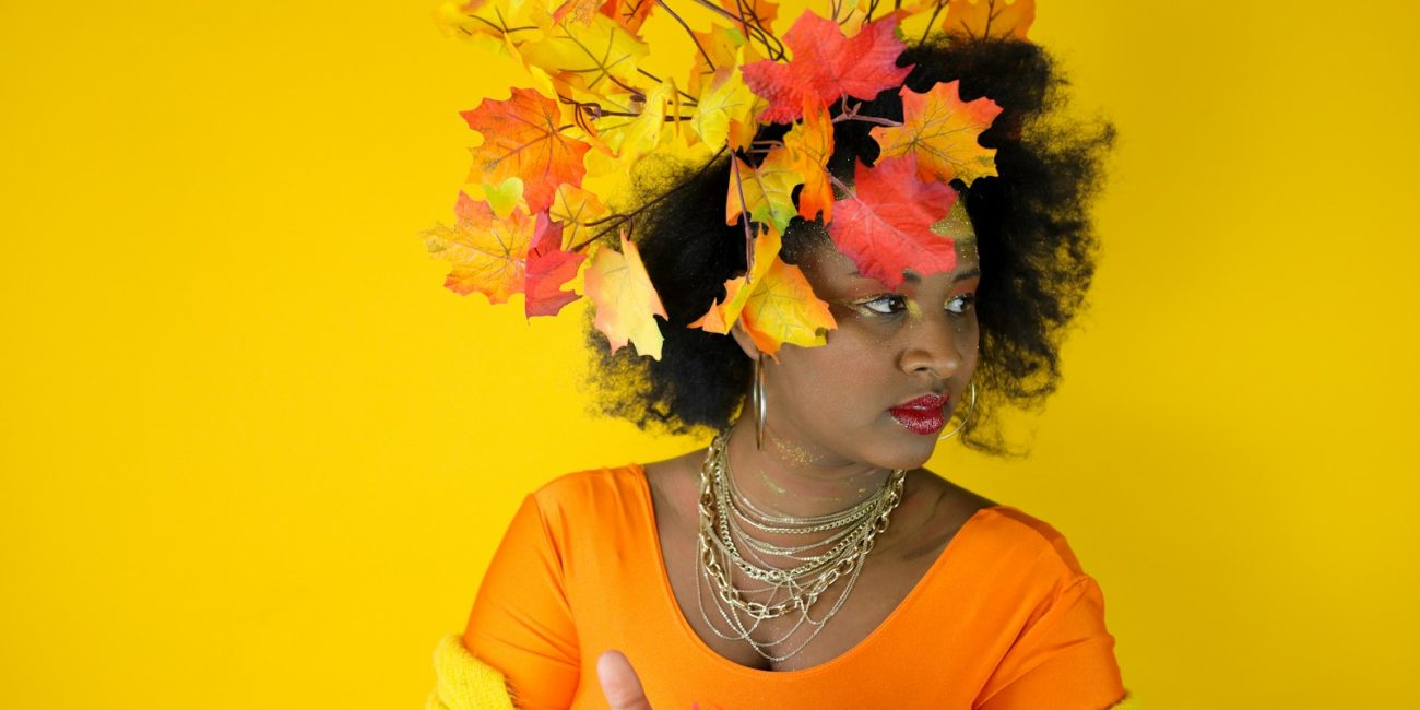 Woman with autumn leaves in her hair and outfit