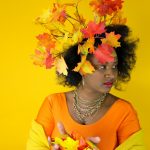 Woman with autumn leaves in her hair and outfit