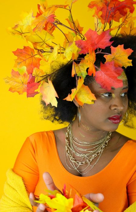 Woman with autumn leaves in her hair and outfit