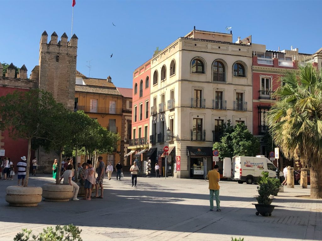 a group of people walking around a city square