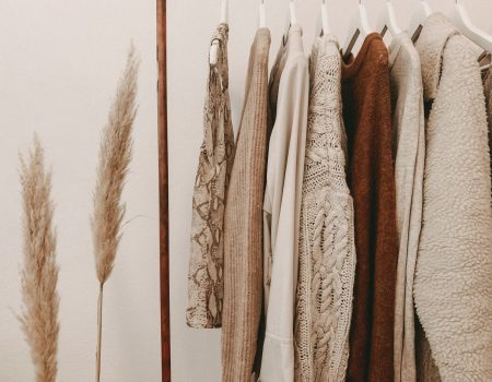 hanged top on brown and white clothes horse