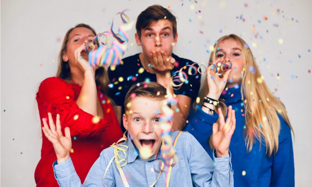 people blowing party favors