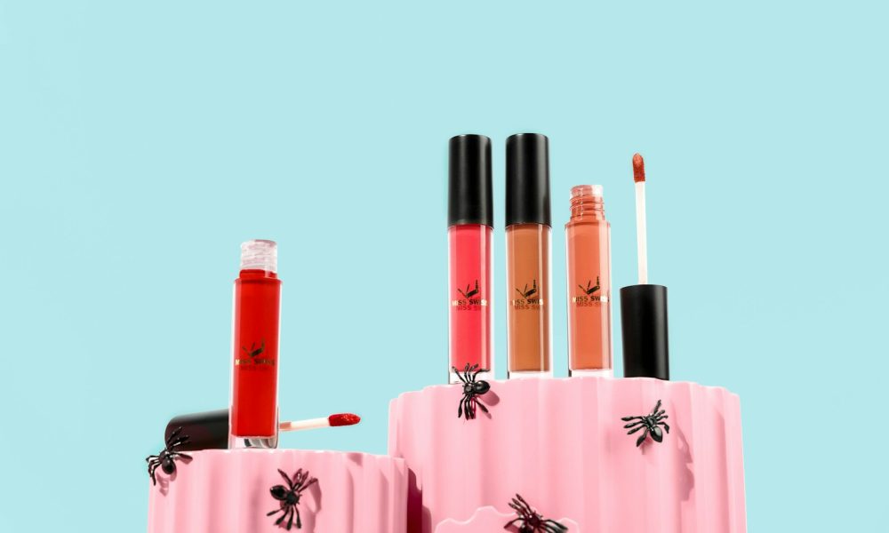 a couple of pink containers filled with different types of lipstick