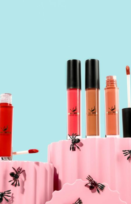 a couple of pink containers filled with different types of lipstick
