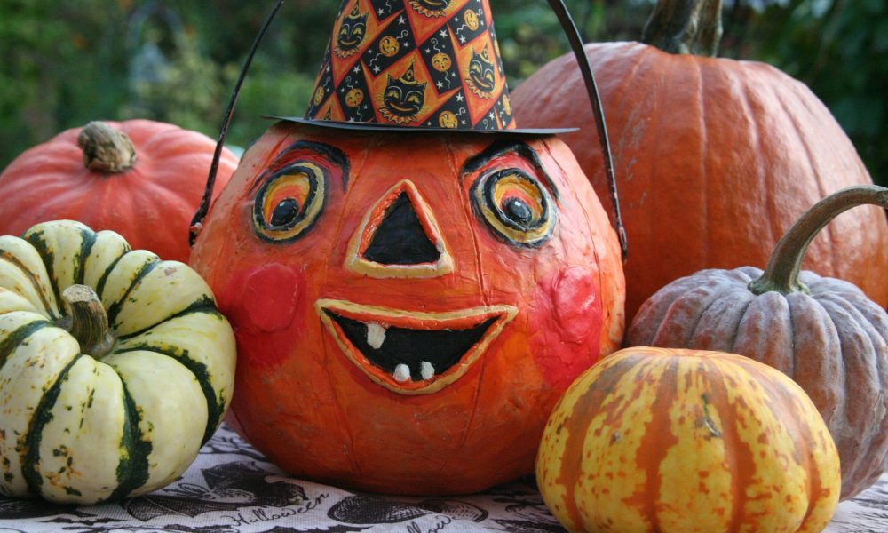 a group of pumpkins with faces painted on them