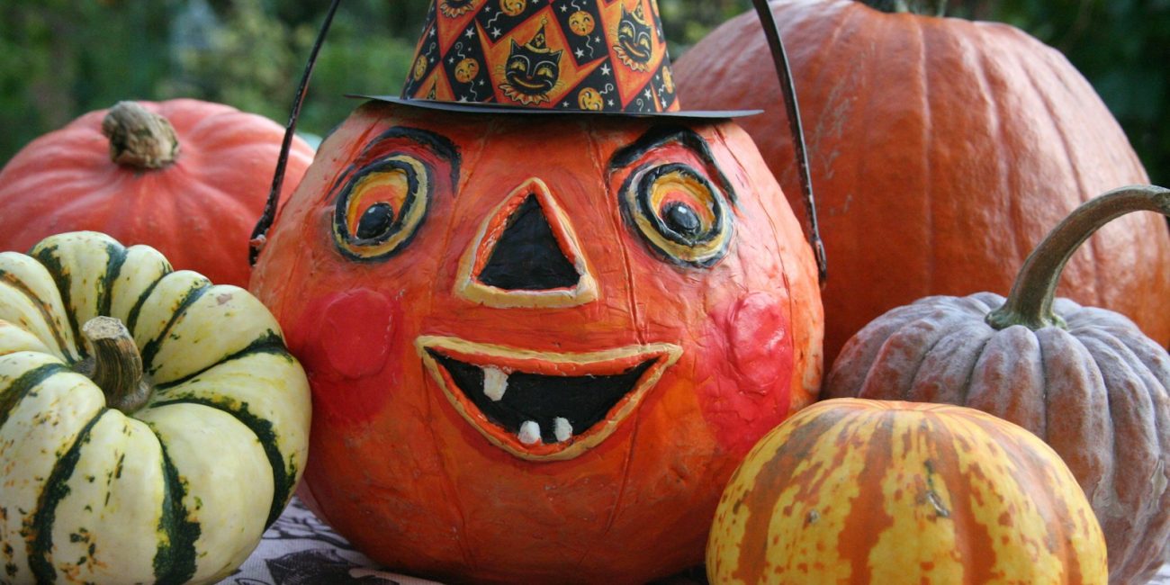 a group of pumpkins with faces painted on them
